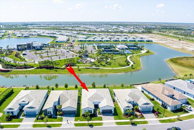 birds eye view of property featuring a residential view and a water view
