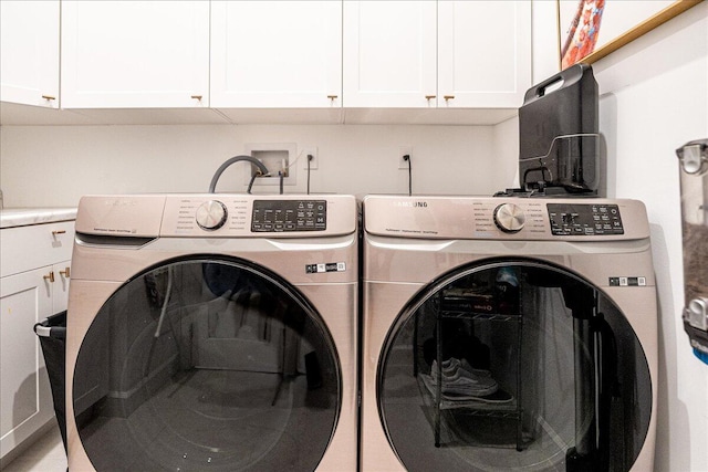washroom featuring cabinet space and washing machine and dryer