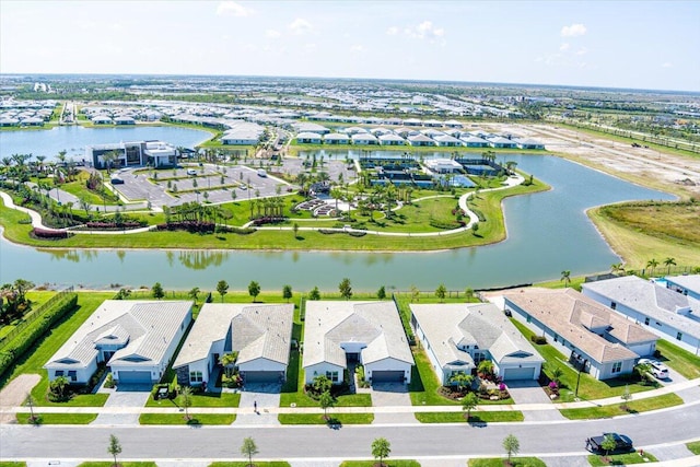 drone / aerial view featuring a residential view and a water view