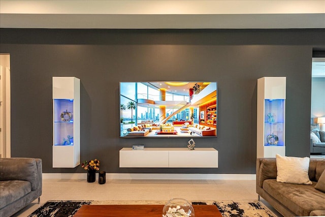 living room featuring baseboards and tile patterned floors