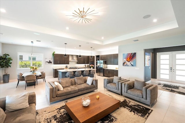 living area with visible vents, recessed lighting, a raised ceiling, french doors, and light tile patterned floors