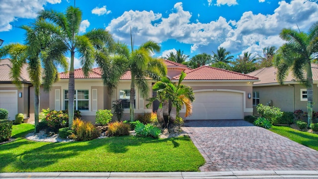 8318 Cameron Cave Dr, Boynton Beach, FL 33473 - mediterranean / spanish house with decorative driveway, stucco siding, a tiled roof, and a garage