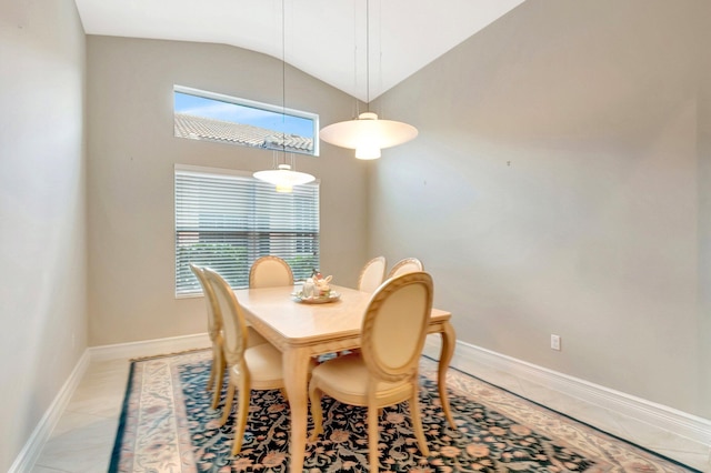 8318 Cameron Cave Dr, Boynton Beach, FL 33473 - dining area with light tile patterned flooring, baseboards, vaulted ceiling, and a healthy amount of sunlight