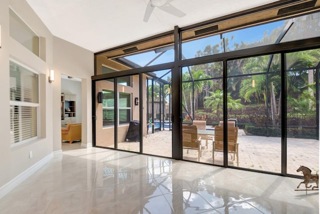 8318 Cameron Cave Dr, Boynton Beach, FL 33473 - doorway with baseboards, floor to ceiling windows, ceiling fan, and tile patterned floors