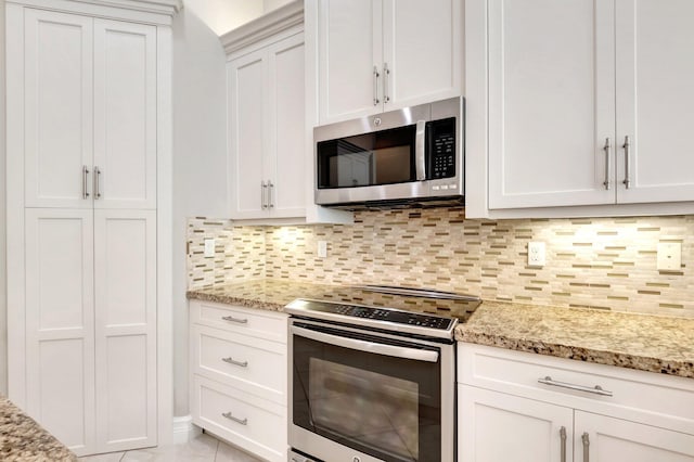 8318 Cameron Cave Dr, Boynton Beach, FL 33473 - kitchen with light stone countertops, decorative backsplash, appliances with stainless steel finishes, and white cabinets