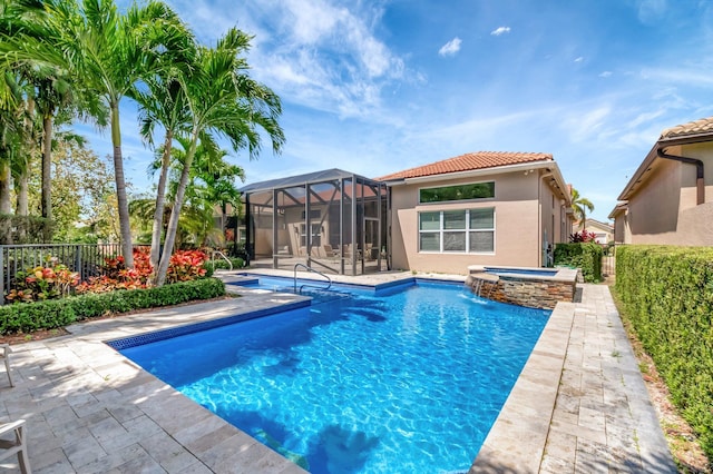 8318 Cameron Cave Dr, Boynton Beach, FL 33473 - view of swimming pool featuring glass enclosure, a pool with connected hot tub, a fenced backyard, and a patio area