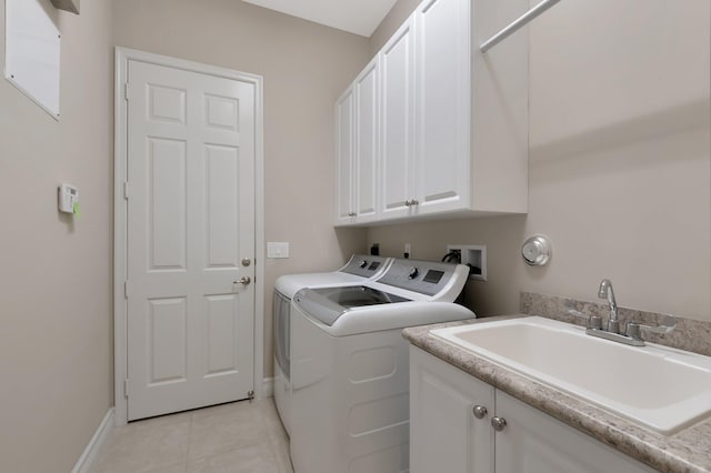 8318 Cameron Cave Dr, Boynton Beach, FL 33473 - laundry room with light tile patterned flooring, baseboards, a sink, cabinet space, and washer and clothes dryer