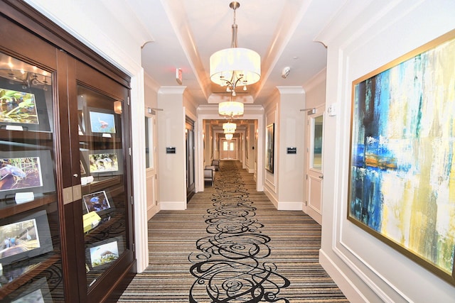 8318 Cameron Cave Dr, Boynton Beach, FL 33473 - corridor with baseboards, a notable chandelier, ornamental molding, and a raised ceiling
