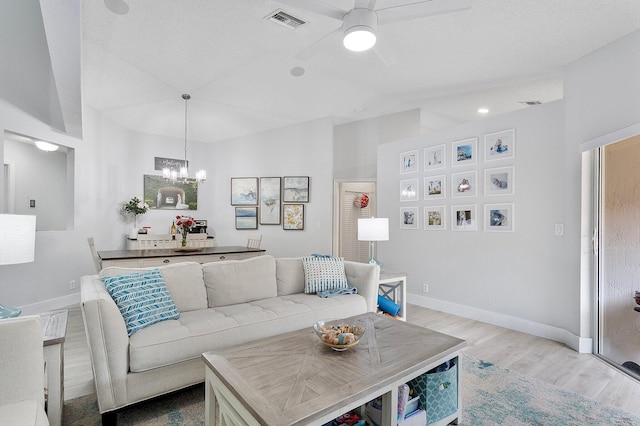 3773 NW 63rd Ct, Coconut Creek, FL 33073 - living room with ceiling fan with notable chandelier, baseboards, light wood finished floors, and visible vents