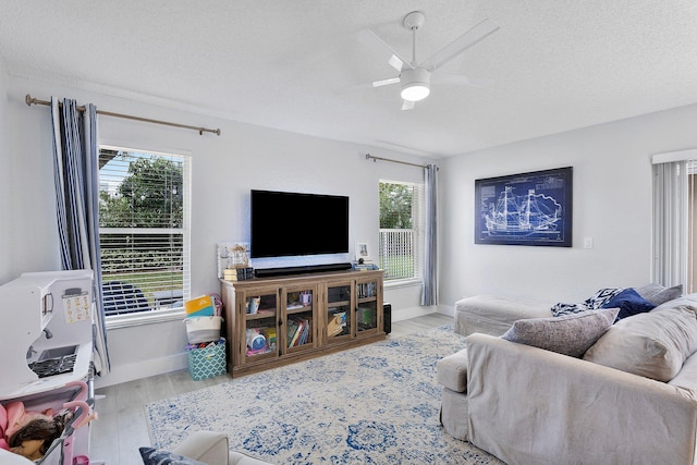 3773 NW 63rd Ct, Coconut Creek, FL 33073 - living area with a textured ceiling, baseboards, ceiling fan, and wood finished floors