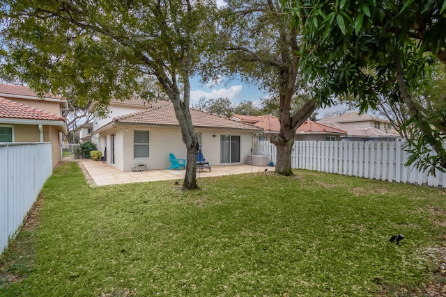3773 NW 63rd Ct, Coconut Creek, FL 33073 - rear view of property with a tiled roof, a lawn, a fenced backyard, stucco siding, and a patio area