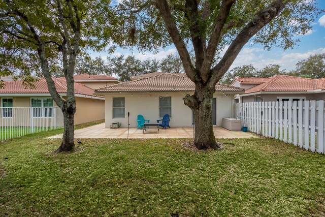3773 NW 63rd Ct, Coconut Creek, FL 33073 - back of property with stucco siding, a patio, a fenced backyard, a tiled roof, and a yard