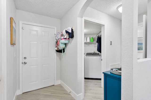 3773 NW 63rd Ct, Coconut Creek, FL 33073 - interior space with arched walkways, a textured ceiling, light wood-style floors, and washer / dryer