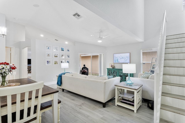 3773 NW 63rd Ct, Coconut Creek, FL 33073 - living area featuring light wood-style flooring, ceiling fan, stairway, arched walkways, and vaulted ceiling