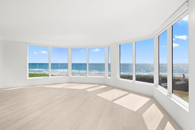 2575 S Ocean Blvd Unit 102S, Highland Beach, FL 33487 - unfurnished sunroom with a water view, wood finished floors, and baseboards