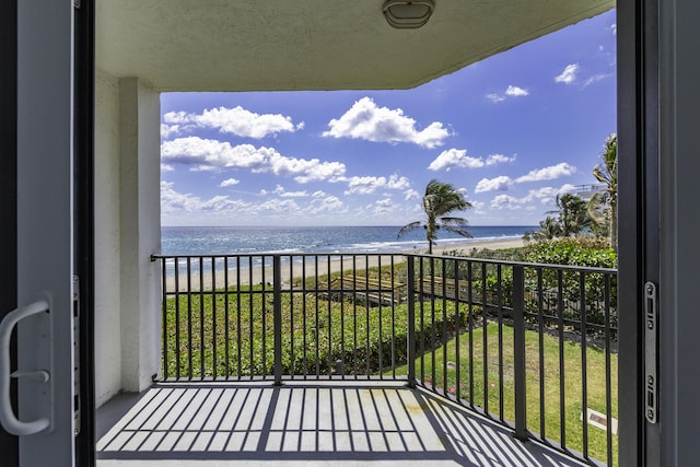 balcony with a water view and a beach view