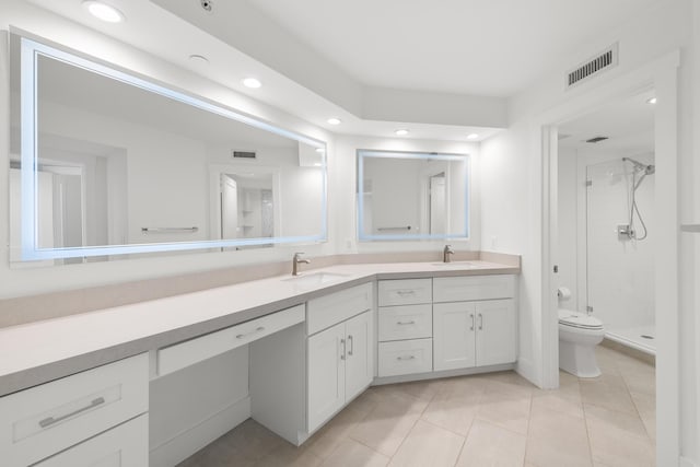full bath featuring toilet, visible vents, a sink, and a shower stall