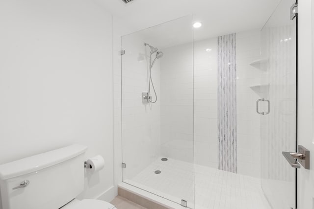 bathroom featuring a stall shower, toilet, and recessed lighting