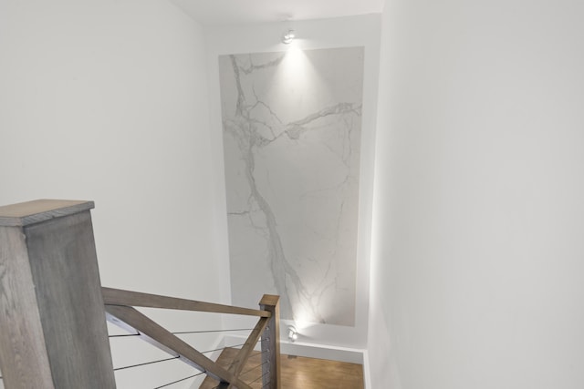 stairway with wood finished floors and baseboards