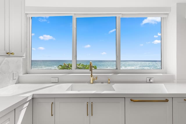 2575 S Ocean Blvd Unit 102S, Highland Beach, FL 33487 - kitchen with a sink, light countertops, and a water view