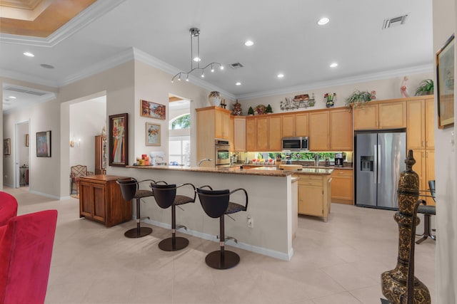 7406 Carmela Way, Delray Beach, FL 33446 - kitchen featuring stainless steel appliances, a breakfast bar area, light brown cabinetry, light tile patterned floors, and crown molding