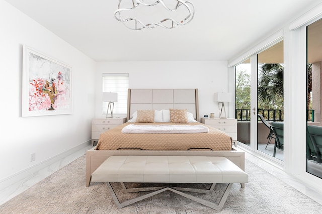 bedroom featuring a chandelier, marble finish floors, access to outside, and baseboards