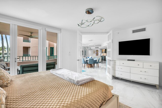 bedroom featuring light marble finish flooring and access to exterior