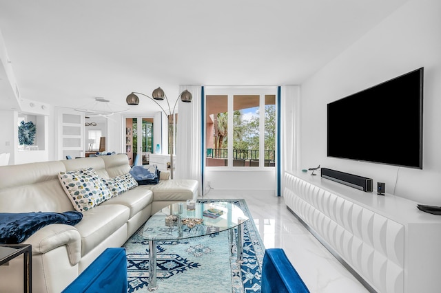 living area featuring marble tiled floors and baseboards