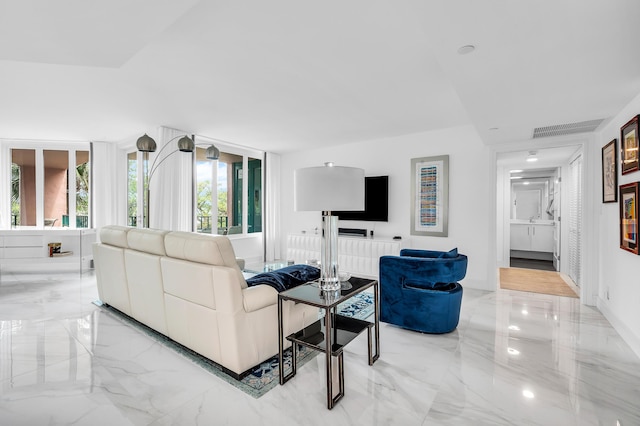 living room featuring light marble finish floors