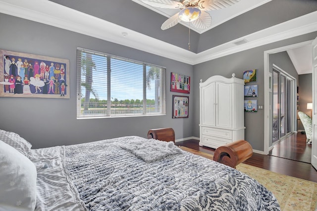 bedroom featuring visible vents, ornamental molding, baseboards, and wood finished floors