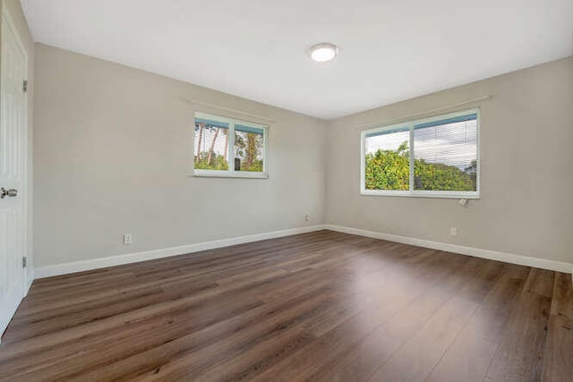 6881 Church St, Jupiter, FL 33458 - empty room with baseboards, wood finished floors, and a healthy amount of sunlight