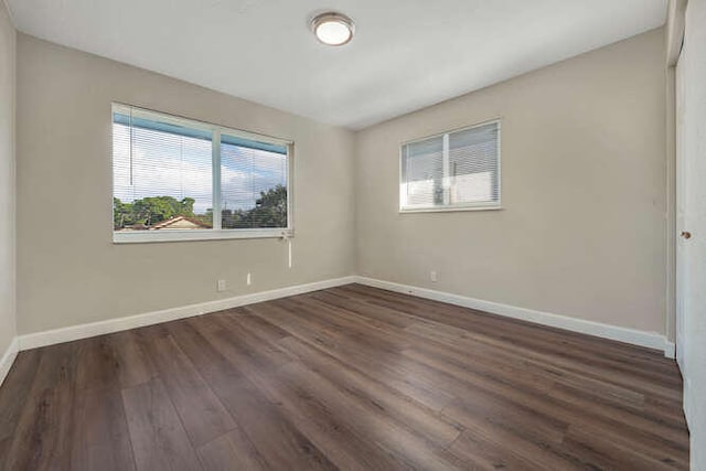 6881 Church St, Jupiter, FL 33458 - unfurnished room with baseboards and dark wood-style floors