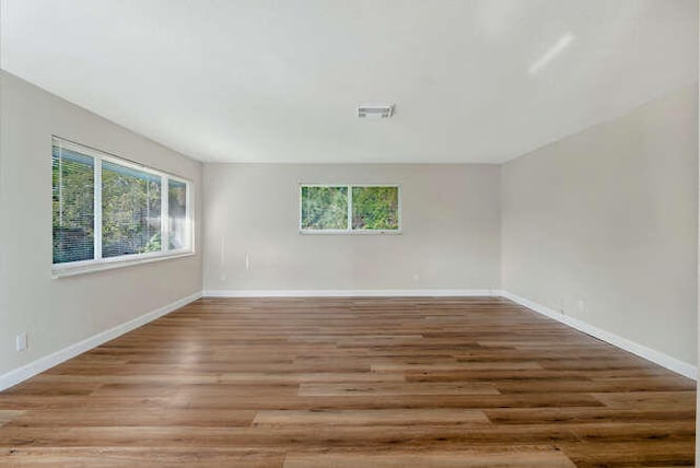 6881 Church St, Jupiter, FL 33458 - unfurnished room with plenty of natural light, baseboards, and wood finished floors