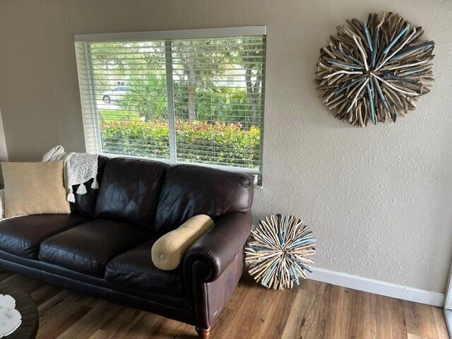 6881 Church St, Jupiter, FL 33458 - living room with baseboards, wood finished floors, and a textured wall