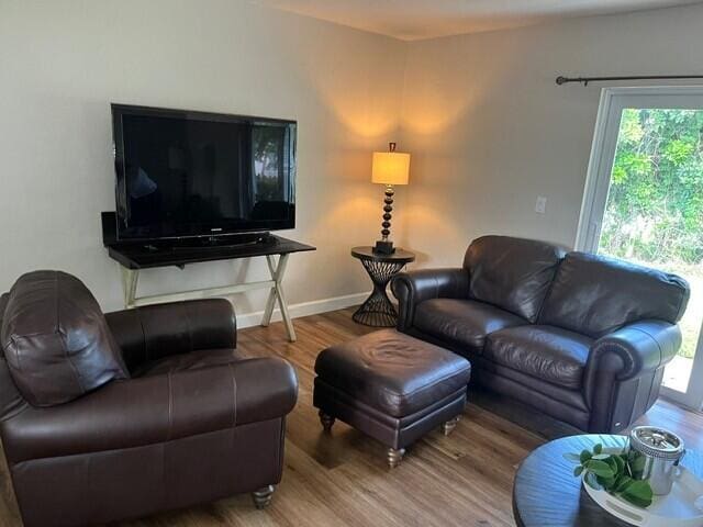 6881 Church St, Jupiter, FL 33458 - living room featuring baseboards and wood finished floors