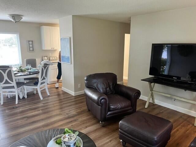 6881 Church St, Jupiter, FL 33458 - living area featuring baseboards and wood finished floors
