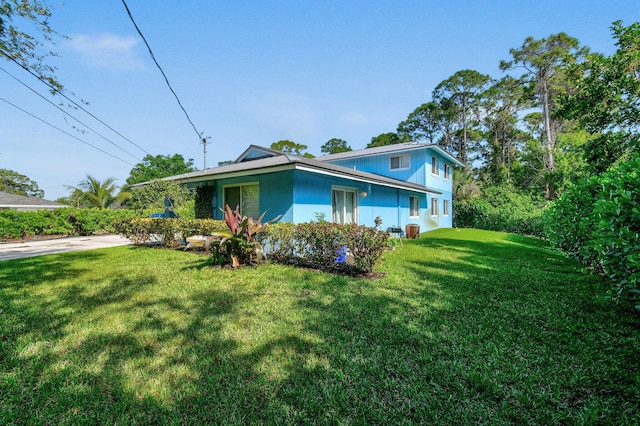6881 Church St, Jupiter, FL 33458 - view of home's exterior with stucco siding and a yard