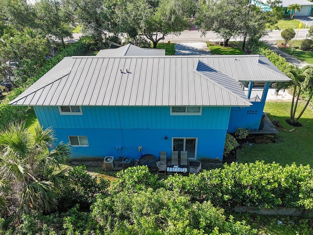 6881 Church St, Jupiter, FL 33458 - back of property with a lawn and metal roof