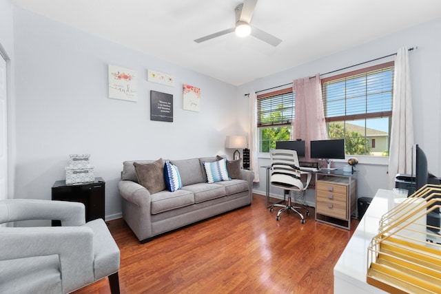 home office with light wood-style floors and ceiling fan