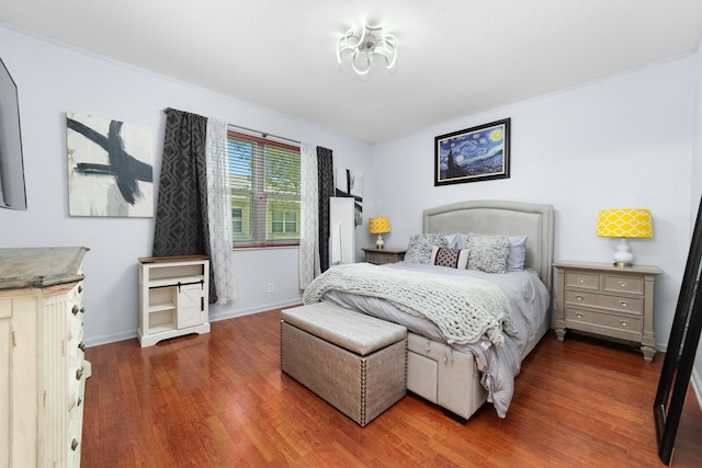 bedroom featuring wood finished floors and baseboards