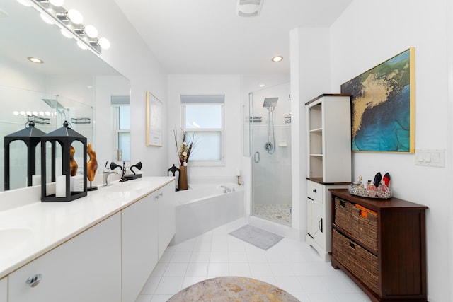 bathroom with a sink, double vanity, tile patterned floors, a stall shower, and a garden tub