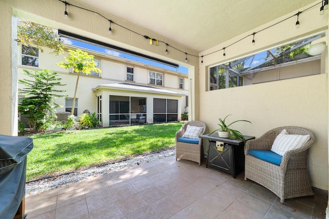 view of patio / terrace featuring glass enclosure, a sunroom, and area for grilling