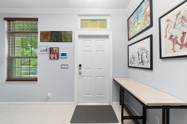 entrance foyer featuring light tile patterned floors, baseboards, and crown molding