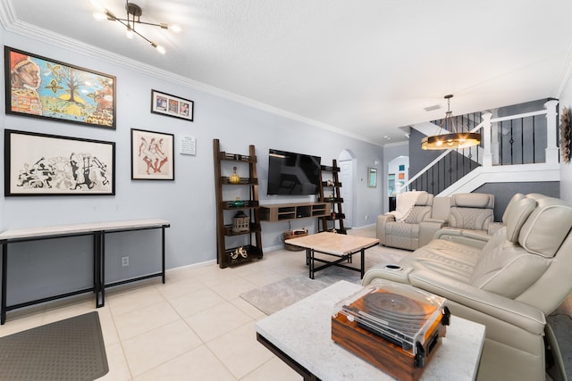living area featuring light tile patterned floors, arched walkways, an inviting chandelier, crown molding, and stairs
