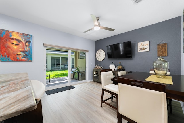 interior space featuring light wood-style floors, baseboards, a ceiling fan, and visible vents