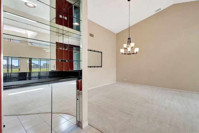interior space with visible vents, high vaulted ceiling, baseboards, a notable chandelier, and carpet