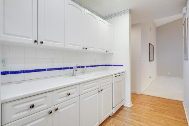 kitchen featuring baseboards, white dishwasher, decorative backsplash, and white cabinets