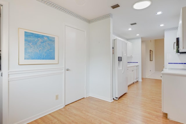 corridor with recessed lighting, light wood-style flooring, and visible vents