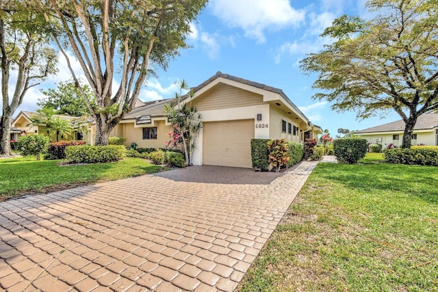 ranch-style house with decorative driveway, an attached garage, a front lawn, and stucco siding