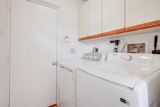 washroom featuring cabinet space and independent washer and dryer